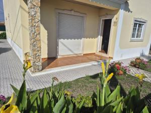 a house with a front porch with a door at Toca dos Coelhos in Silveira