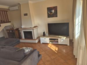 a living room with a large flat screen tv at Toca dos Coelhos in Silveira