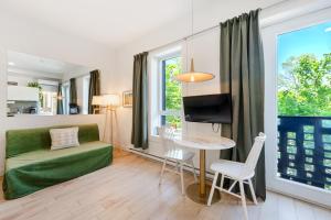 a living room with a green couch and a table at Lofts Le Plateau in Montreal