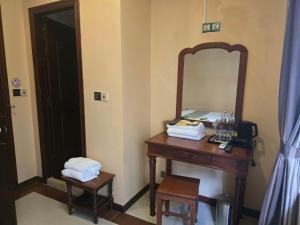 a bathroom with a wooden table with a mirror at LT Home Stay in Siem Reap