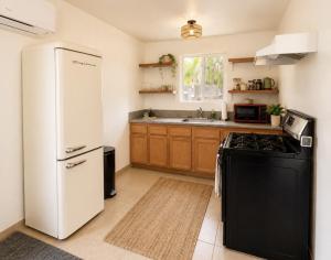 a kitchen with a white refrigerator and a stove at Ojai Pixie House in Ojai