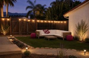 a backyard with a couch and lights on a fence at Ojai Pixie House in Ojai
