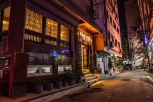 a building with plants on a street at night at Hotel Swastik in Kathmandu