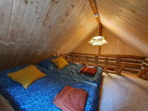 a bedroom with a bed in a attic at Ostaya - Mountain Cottage in Obidza