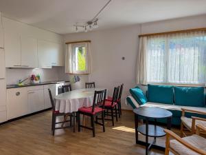 a kitchen and a living room with a table and chairs at Res Roncaccio, Cancro by HolAp SA in Vairano