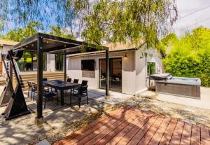 an outdoor patio with a table and a grill at Downtown Ojai Gem in Ojai