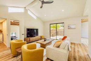 a living room with a couch and chairs and a tv at Downtown Ojai Gem in Ojai