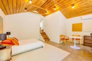 a bedroom with a bed and a desk and a table at Downtown Ojai Gem in Ojai