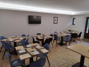 a dining room with tables and chairs and a tv at B&B Il Prugnolo in Castel di Sangro