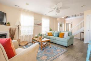 a living room with a couch and a table at CoastalBoho-Spacious 4BDtownhouse 3 mi from beach in Rehoboth Beach