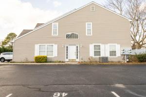 a house with a car parked in front of it at CoastalBoho-Spacious 4BDtownhouse 3 mi from beach in Rehoboth Beach