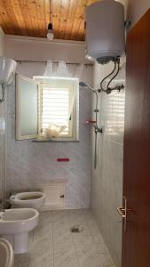 a bathroom with a toilet and a sink and a shower at B&B da Alessandro in Palmi