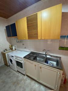 a kitchen with a sink and a stove at B&B da Alessandro in Palmi +8 photos