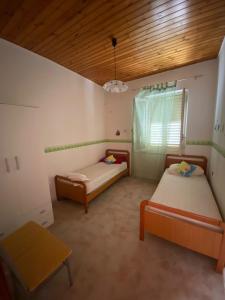 a room with two beds and a window in it at B&B da Alessandro in Palmi