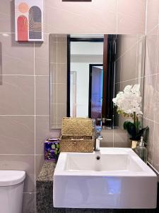 a bathroom with a sink and a toilet and a mirror at McBride Suites in Punta Engaño +5 photos