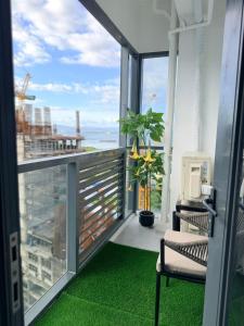 a balcony with a chair and a view of the ocean at McBride Suites in Punta Engaño