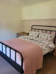a bedroom with a bed with a black frame at Brent Top in Penrith