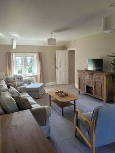 a living room with a couch and a table at Brent Top in Penrith