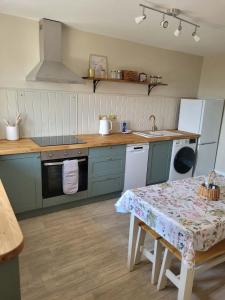 a kitchen with a table and a sink at Brent Top in Penrith