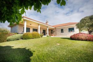 a house with a lawn in front of it at Casa dos olivos in Ourense