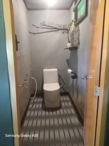 a small bathroom with a toilet in a room at Lake Face Cabana in Tissamaharama +39 photos