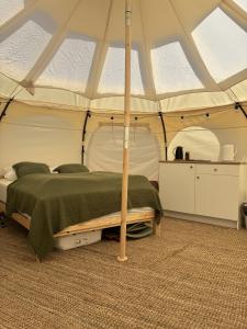 a bedroom with a bed in a tent at Glamping, Tåsinge - Svendborg in Svendborg
