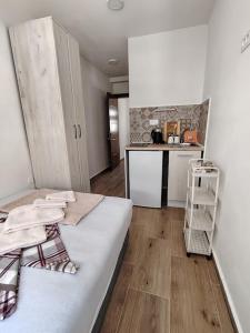 a living room with a bed and a kitchen at Apartmani CECA 012 Sutomore in Sutomore