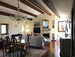 a living room with a bed and a table and a chandelier at Casa Olivi, Fermo in Fermo