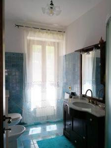 a bathroom with a sink and a toilet at Casa Olivi, Fermo in Fermo +13 photos