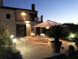 a patio with a potted plant and an umbrella at Casa Olivi, Fermo in Fermo