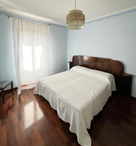 a bedroom with a bed with a white blanket on it at Casa Olivi, Fermo in Fermo