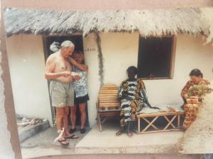 a man and a woman standing outside of a house at les baobabs in Mbour