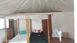 a small room with a bed in a tent at les baobabs in Mbour