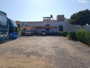 a group of buses parked in a parking lot at Hotel Dubái in Tacna