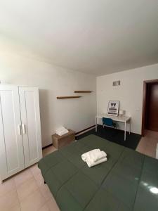 a room with a bed and a table and a desk at Riva Bianca in Ameglia