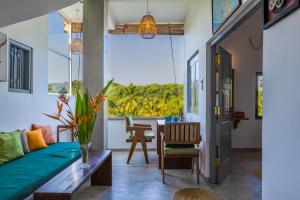 a living room with a couch and a table at Old Chilli House in Unawatuna