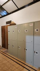 a row of lockers in a room with a wall at SEMERU HOSTEL MALANG in Malang
