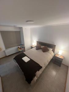 a bedroom with a large bed with two night stands at Ingloo in Puerto Natales