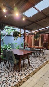 a patio with tables and chairs on a rug at SEMERU HOSTEL MALANG in Malang