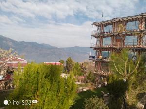 a building under construction with mountains in the background at BHURBAN view APARTMENTS in Murree