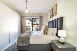 a bedroom with a large bed and a window at #AlimamaSpaces The Contemporary Retreat in Midrand