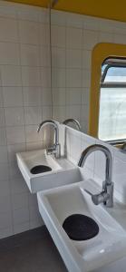 a bathroom with two sinks and a mirror at Train Lodge Amsterdam in Amsterdam +62 photos