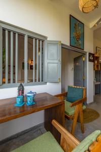 a living room with a table and a chair at Old Chilli House in Unawatuna