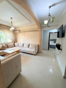 a large living room with couches and a tv at casa jihan playa TGV in Tangier