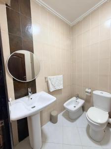 a bathroom with a sink and a toilet and a mirror at casa jihan playa TGV in Tangier +5 photos