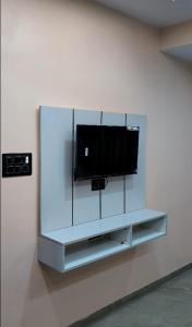 a flat screen tv on a wall in a room at Hotel Sai Vandan in Nagpur