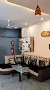 a living room with a couch and a glass table at Hotel Sai Vandan in Nagpur