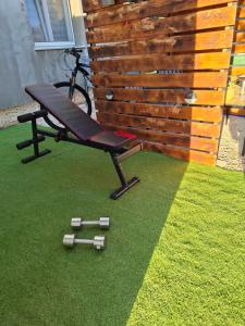 a bench sitting on the grass next to a fence at MARANGUN Drage apartman in Drage