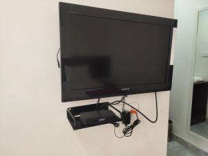 a flat screen tv hanging on a wall at Raya Raj Anugraha in Kumbakonam