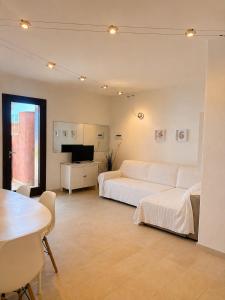a living room with two beds and a table at Residence Borgo Punta Villa in La Maddalena +137 photos